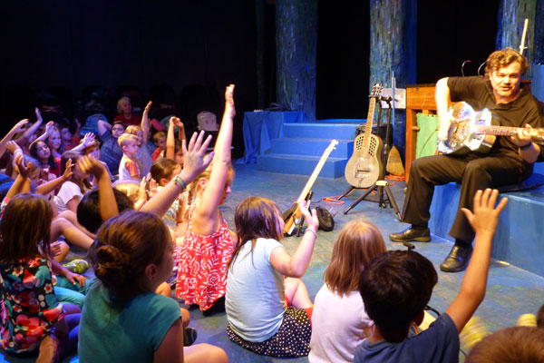 Home 3 Students hands raised School Assembly Show